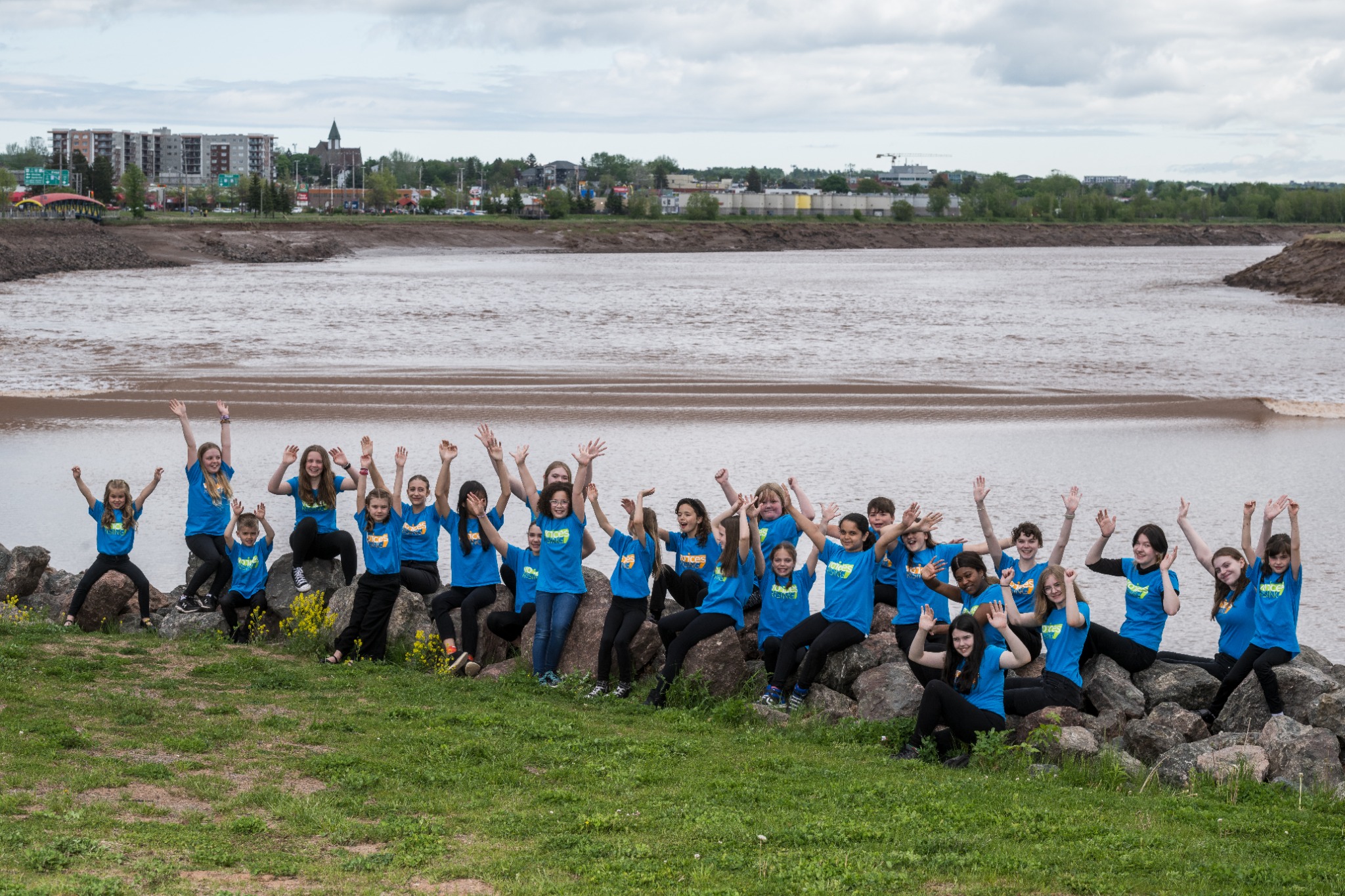 Voices Rising singers together by the river